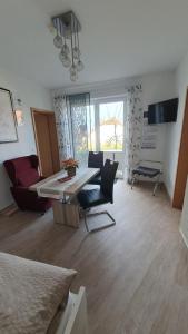 a living room with a table and a couch at Apartment Christa in Schwendi