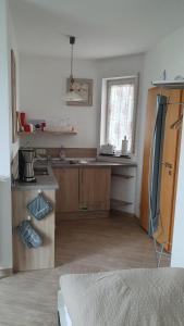 a room with a kitchen with a counter and a window at Apartment Christa in Schwendi