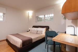 A bed or beds in a room at Bright, Cosy Studio close to Glyfada Beach & Center