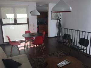 a living room with a table and chairs at Patio del Bastion 107 in Colonia del Sacramento