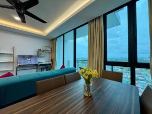 a living room with a couch and a table with flowers on it at Vivacity Cozy Jazz4 2R1B wNetflix, 7pax YPM1202 in Kuching