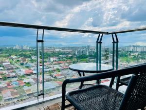 a balcony with a table and a view of a city at Vivacity Cozy Jazz4 2R1B wNetflix, 7pax YPM1202 in Kuching
