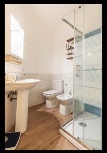 a bathroom with a sink and a toilet and a glass shower at Binario 8 Catania Stazione Centrale in Catania +31 photos