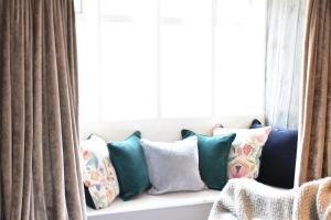 a bunch of pillows sitting on a window sill at Cotswold Gardens Bed and Breakfast in Stow on the Wold +25 photos
