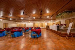 a large banquet hall with red and blue tables and chairs at Aamari Resort in Rāmgarh +98 photos
