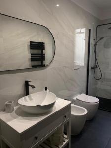 a white bathroom with a sink and a toilet at Villa Perla del Sole in Baiardo +47 photos