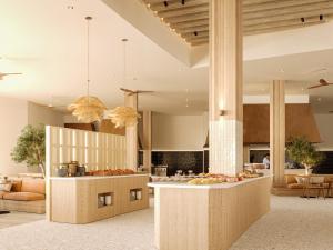 an open kitchen and living room with a table with fruits on it at PortoBay Blue Ocean in Albufeira