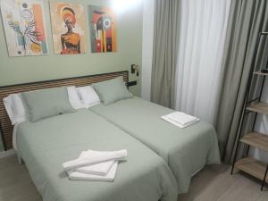 a hotel room with two beds with towels on them at El Rincon de Calatayud in Calatayud