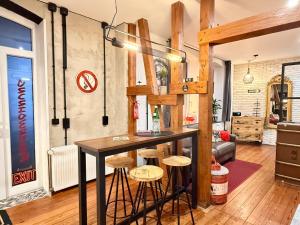 a bar in the middle of a room with stools at Femo Ziegelei - tiny Loft - separater Eingang - Parkplatz in Burbach
