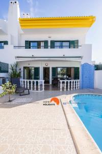 a villa with a swimming pool and a house at #039 Family Private Pool AC in Vale de Pedras