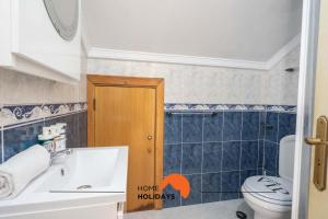 a bathroom with a toilet and a sink at #039 Family Private Pool AC in Vale de Pedras
