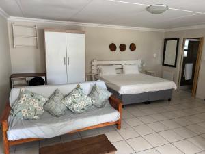 a living room with two beds and a couch at Eagles Overnight in Queenstown