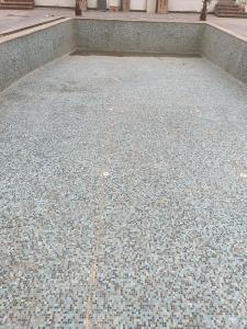 a tiled floor in front of a building at The Rules Club in Vrindāvan