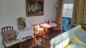 a living room with a table and chairs at Prawdzicówka in Zachełmie +53 photos