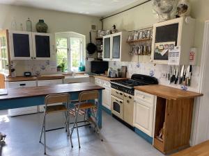 a kitchen with white cabinets and a wooden counter top at Lower Buckton Country Living Big House near Ludlow 6 bedrooms sleep 12 in Leintwardine +41 photos