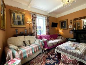 a living room with a couch and a table at Lower Buckton Country Living Big House near Ludlow 6 bedrooms sleep 12 in Leintwardine