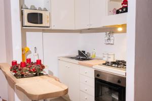 a small kitchen with a table and a microwave at Camelia in Arona