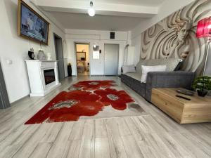 a living room with a couch and a red rug at Silver De Lux in Bacău