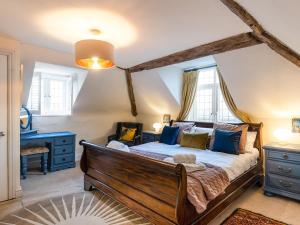 a bedroom with a large bed with blue furniture at Riverside Manor in Offenham