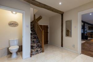 a bathroom with a toilet and a staircase at Riverside Manor in Offenham +24 photos