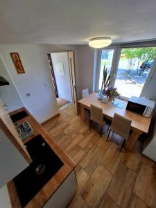 a kitchen and dining room with a table and chairs at Agroturystyka KRAINA JEZIOR in Ludwin
