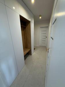 a hallway with white cabinets and a walk in closet at Mountain Heim Apartment in Poprad +1 photo