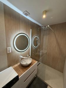 a bathroom with a sink and a mirror at Mountain Heim Apartment in Poprad