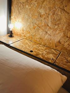 a bedroom with a bed and a light on a wall at Pig Dive Hostel Moalboal in Moalboal +48 photos