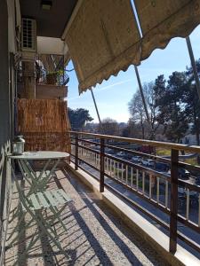 a table and chairs on the balcony of a building at Mylos House in Tríkala
