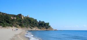 a beach with people on the sand and the ocean at Il Nido in Muravera +45 photos