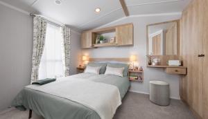 a bedroom with a large bed and a window at Llanrhidian Holiday Park in Llanmorlais