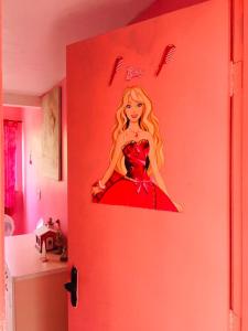 a door with a picture of a woman in a red dress at Casa da Barbie da Serra in Pacoti