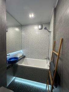 a bathroom with a bath tub and a toilet at Уютная и стильная квартира в центре города Караганда in Karagandy +16 photos