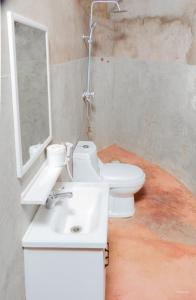 a bathroom with a white sink and a toilet at Kili View Maasai Lodge in Longido