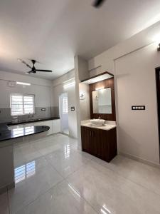 a large bathroom with a sink and a mirror at G 5 Gayathri Enclave 2 Bedroom Fully Furnished Apt in Trivandrum