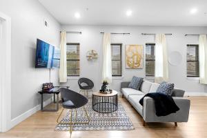 a living room with a couch and a table and chairs at 2C - Parking Cred, Early CI, King Bed, Sleeps 6 - 30mins to NYC in Newark
