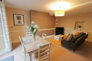 a living room with a table and a couch at Large clifton one bed flat and parking in Bristol
