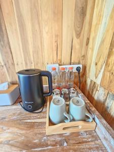 a wooden tray with a coffee maker and mugs at Glamour camping bedugul in Bedugul