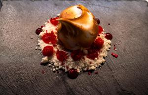a dessert with strawberries and ice cream on a table at Court House Kinlough in Kinlough