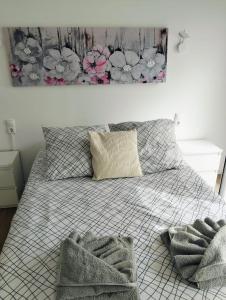 a bedroom with a bed with two towels on it at Casa do Mar in Funchal