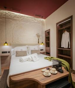 a bedroom with a large bed with towels on it at LIRIUM Casa Patio in Seville +52 photos