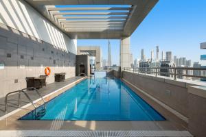 a swimming pool on the top of a building at Royal Continental Suites Business Bay - Deluxe Apartments in Dubai