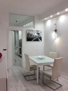 a dining room with a white table and chairs at Bella Vernazza with AC and Balcony in Vernazza +24 photos