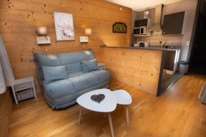 a living room with a couch and a table at La Ferme du Lay in Arâches-la-Frasse