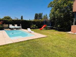 a backyard with a swimming pool and a slide at Chacras de Coria Casa del Descanso in Ciudad Lujan de Cuyo