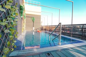 a swimming pool on the balcony of a building at Concorde Creek View Hotel Bur Dubai in Dubai