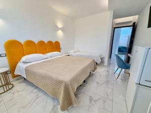 two beds in a hotel room with a large window at Dimora Prometeo in Bari +78 photos
