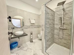 a bathroom with a shower and a sink and a toilet at Dimora Prometeo in Bari
