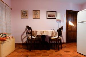 a kitchen with a table and two chairs at Montello Hill apartment in Ciano