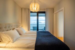 a bedroom with a bed with a view of the ocean at Pearl Suite in Kuningatarranta Hanko in Hanko